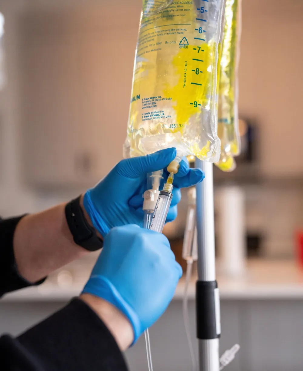 AMIV IV therapy drip being prepared by a clinician